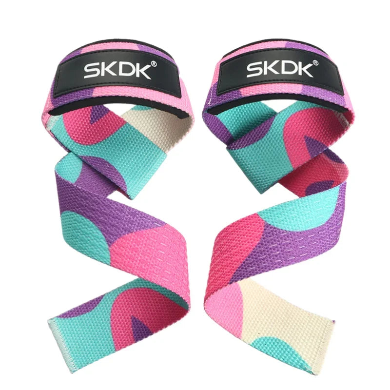 Pair of SKDK weightlifting straps with a colourful abstract pink, purple, and teal pattern on a white background.