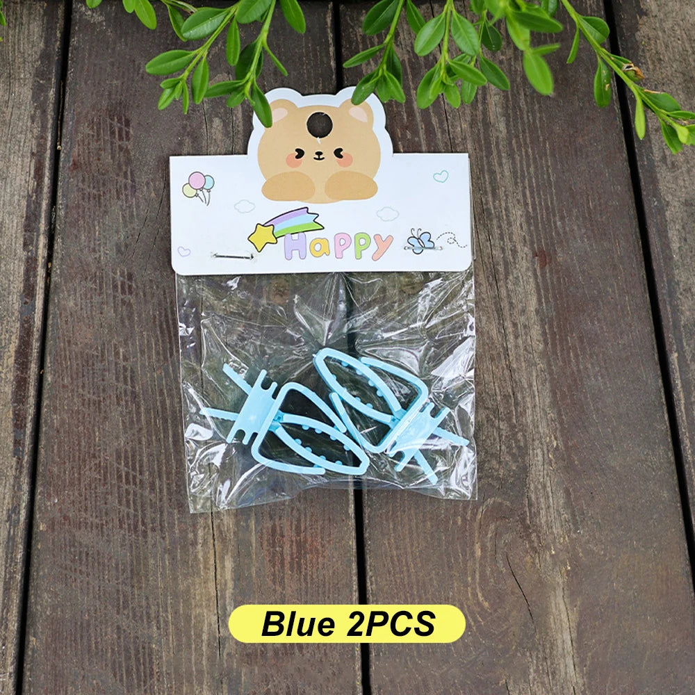 Two light blue geometric hair clips in a plastic bag with a cute bear-themed display card.