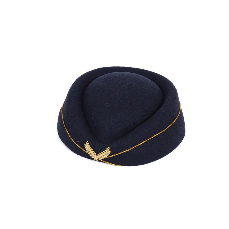 Navy blue vintage-style pillbox stewardess hat with gold piping and a metallic leaf badge detail.
