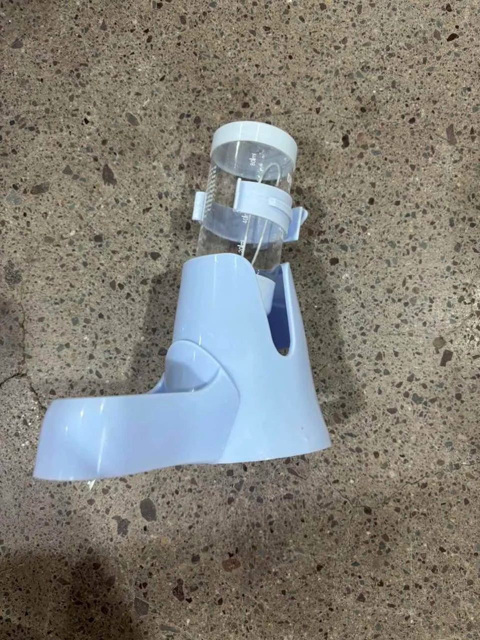 Light blue plastic small pet water dispenser with a clear, graduated inverted bottle.