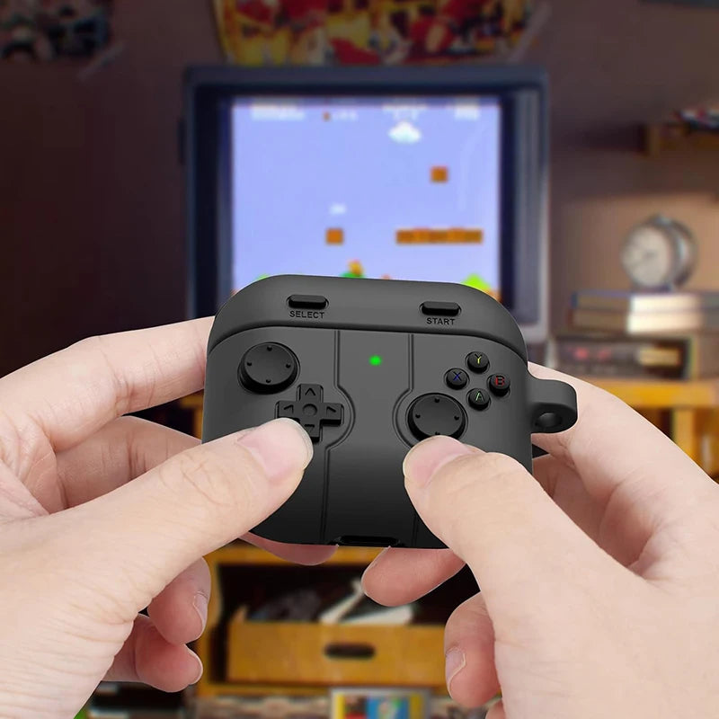 Black silicone AirPods case with a retro handheld games console design, held in front of a gaming screen.