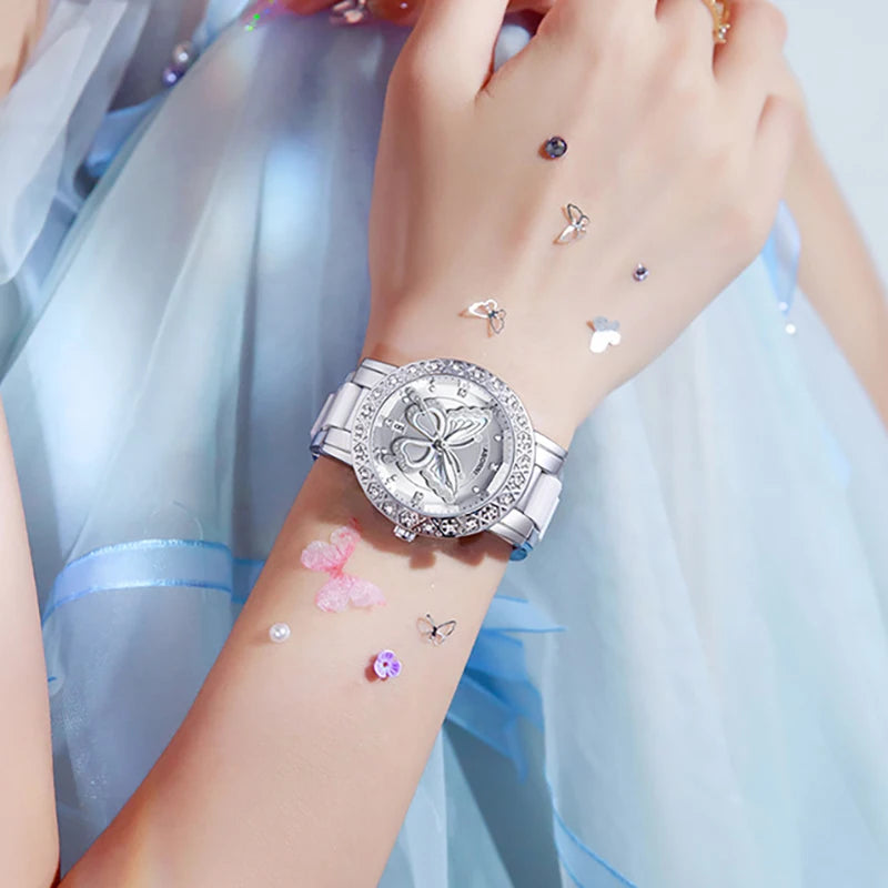 Luxury silver-tone women's watch featuring a crystal-embellished bezel and a delicate butterfly design on the dial.