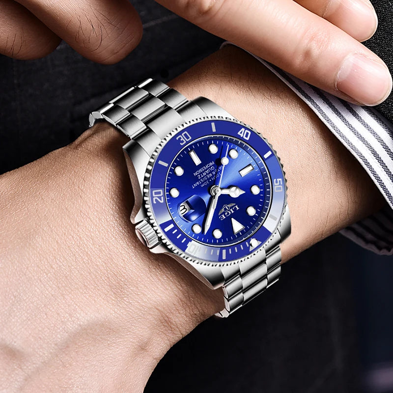 Men's stainless steel quartz watch with a blue bezel, sunray blue dial, and a silver metal link strap on a wrist.