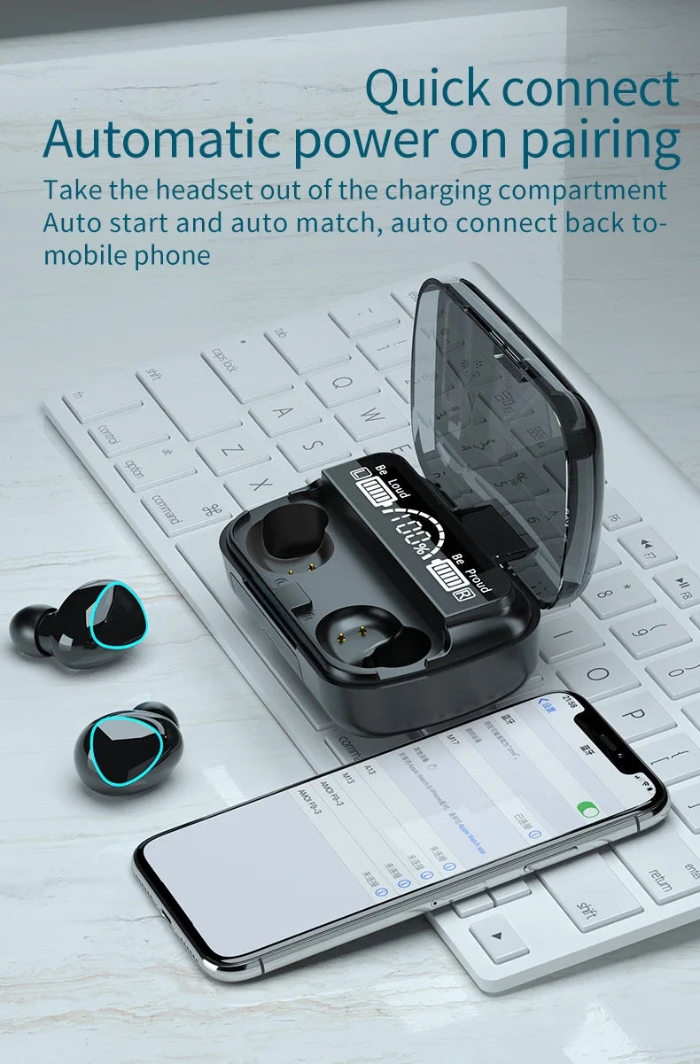 Black wireless earbuds with glowing blue rings, charging case with digital display, and smartphone on a white keyboard.