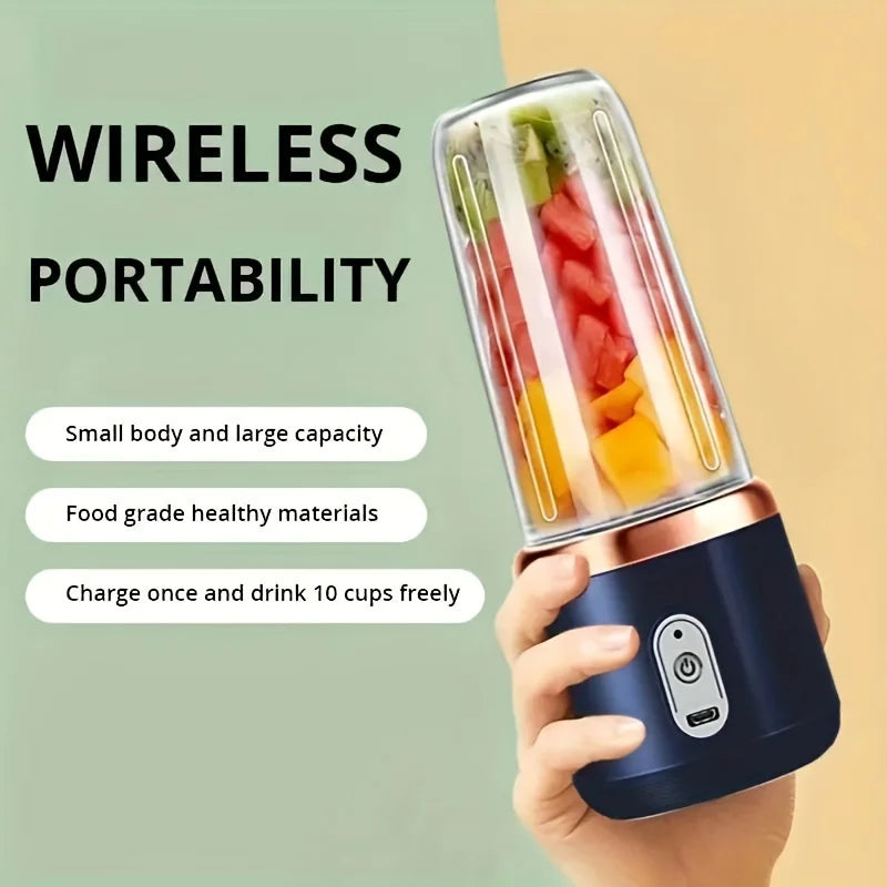 Portable wireless blender with a dark blue base, rose gold trim, and a clear cup filled with chopped fruit.