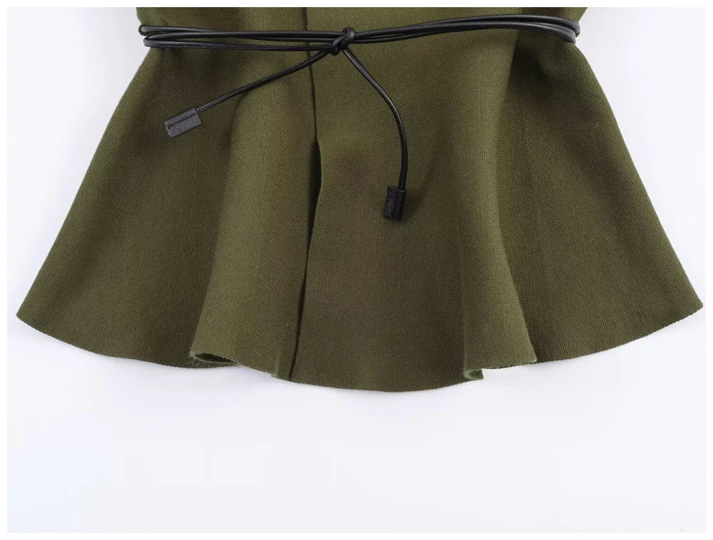Olive green knitted peplum top with a thin black waist-tie belt.
