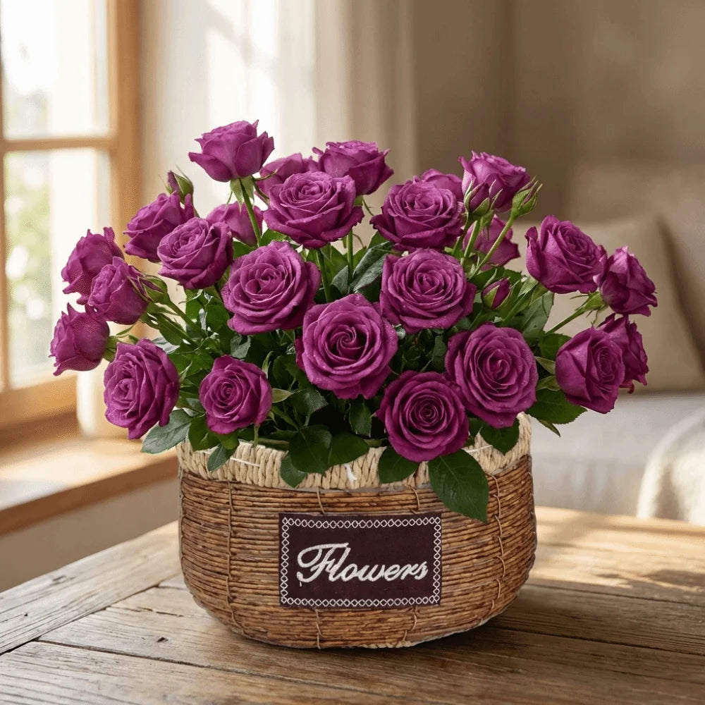 Vibrant purple roses in a rustic, woven brown basket with a "Flowers" label, sitting on a wooden table.