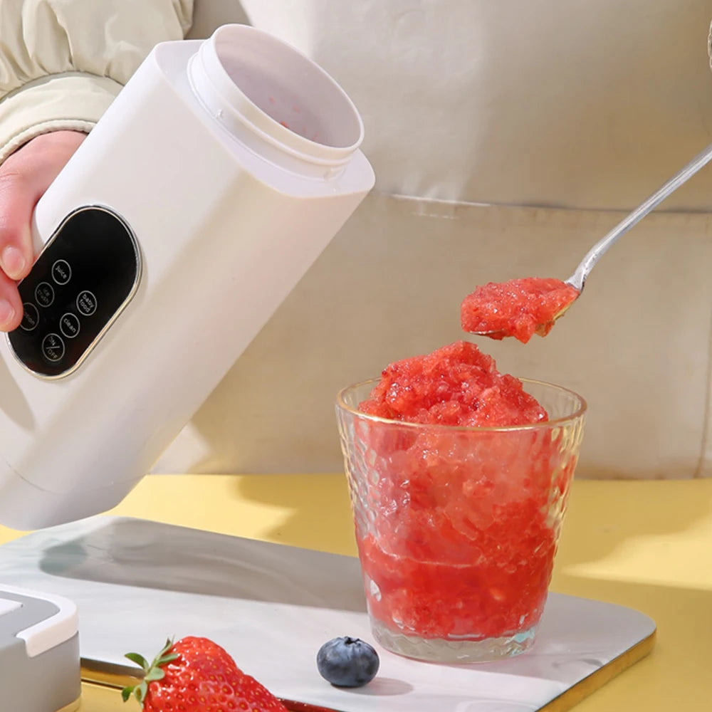 White portable personal blender with touch buttons, pouring a strawberry slush into a textured glass.