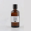 50ml amber glass bottle of Darjeeling Tea essential oil with a black screw cap and simple white label.