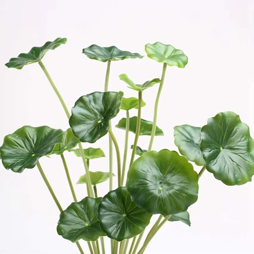 Artificial lotus plant with multiple glossy, round, green leaves on thin stems against a plain white background.