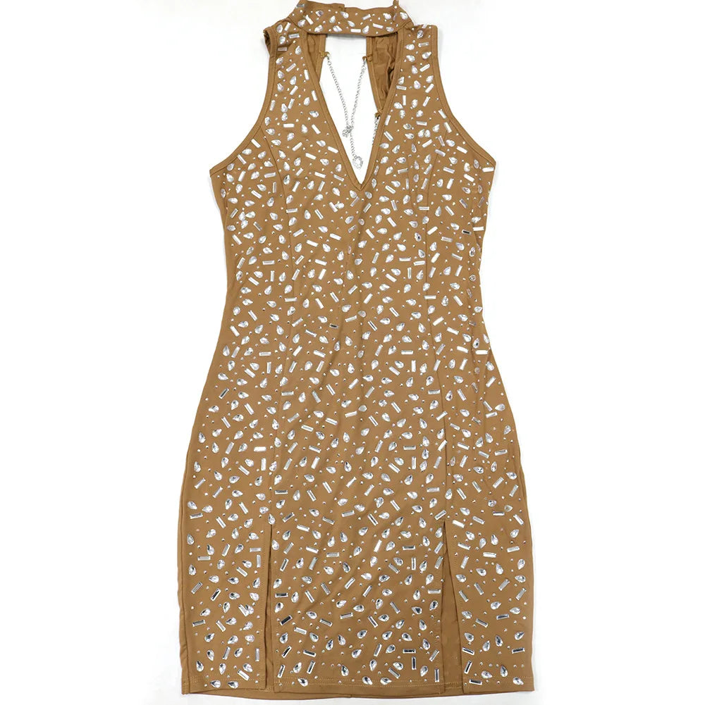 Tan sleeveless bodycon dress, covered in rhinestones with a halter neck, choker, and back chain.