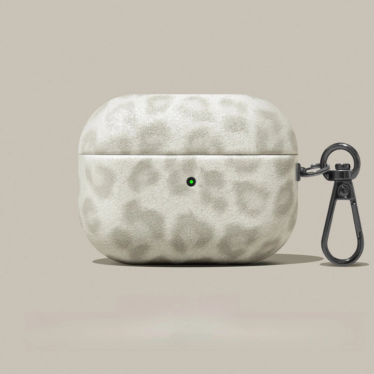 Beige leopard-print AirPods Pro case with a textured finish and a black metal carabiner clip.