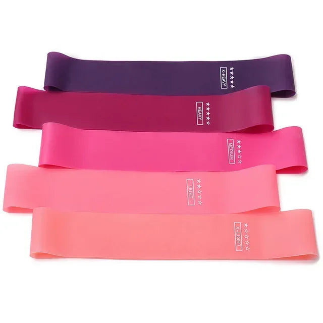 Five resistance bands in graduated shades from purple to light peach, each labelled with its resistance level.
