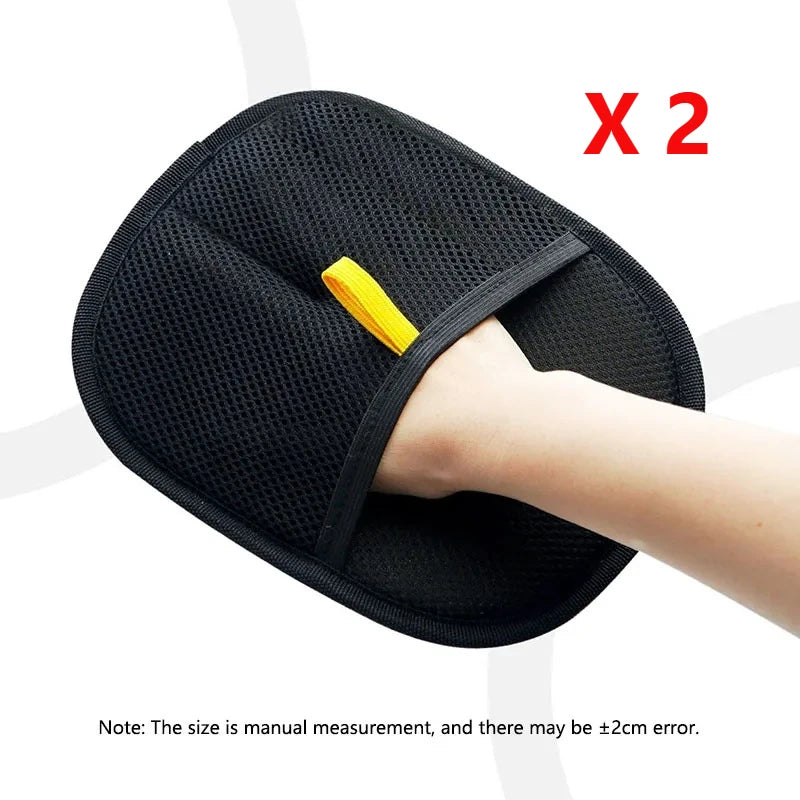 Pack of two black mesh exfoliating mitts with an elasticated yellow strap, shown being worn on a hand.
