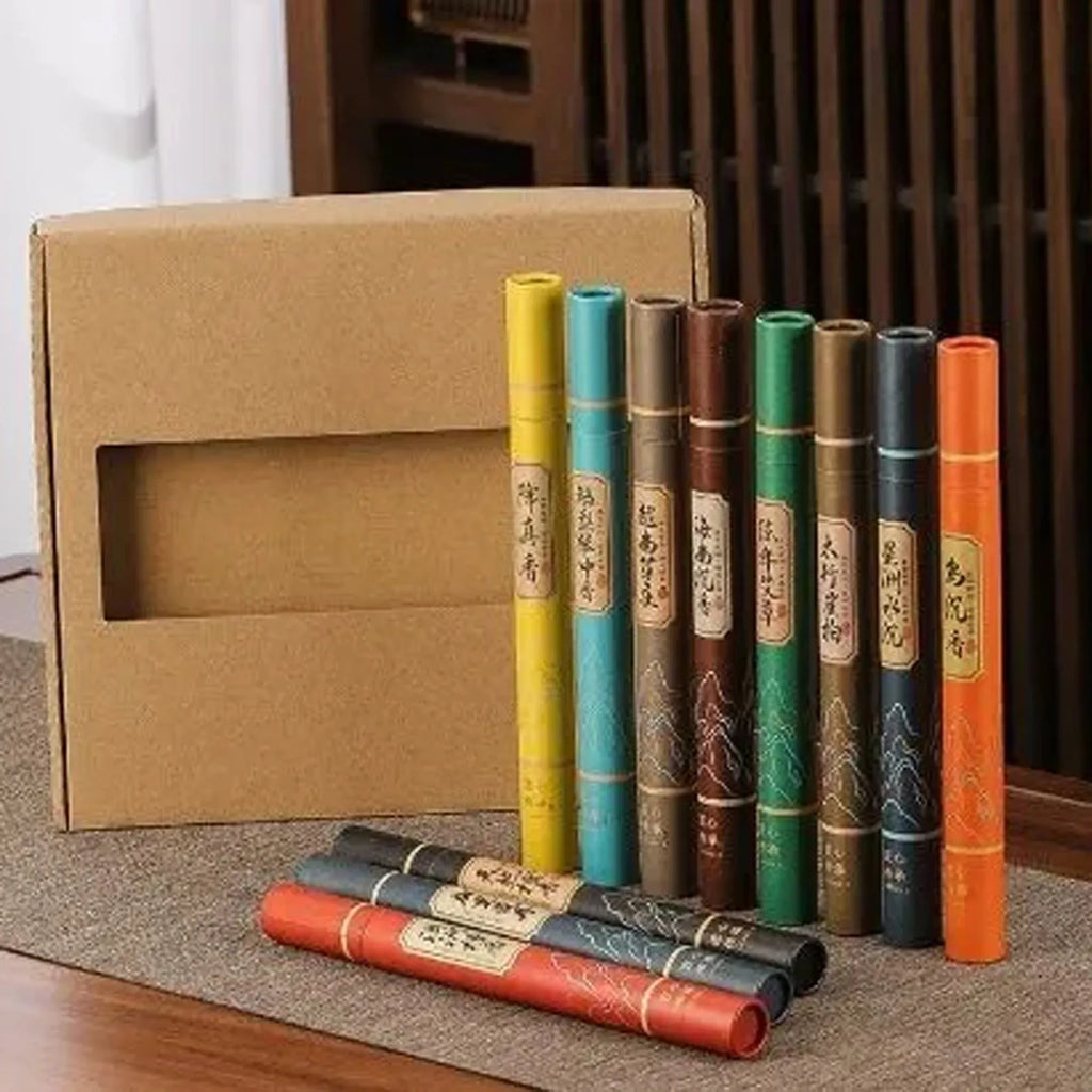 Set of colourful, slender cardboard incense tubes featuring traditional Asian mountain-style patterns and labels.