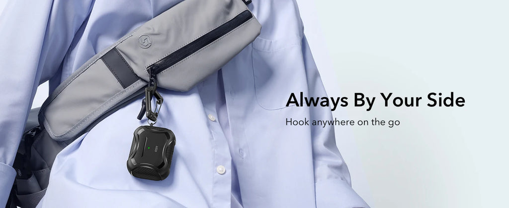 Black rugged protective case for AirPods, attached to a grey bag with a carabiner.