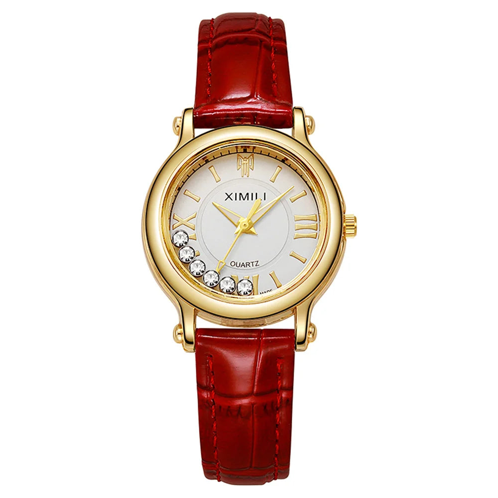 Women's quartz watch with a gold-tone round case, white dial with crystal accents, and a red textured leather strap.