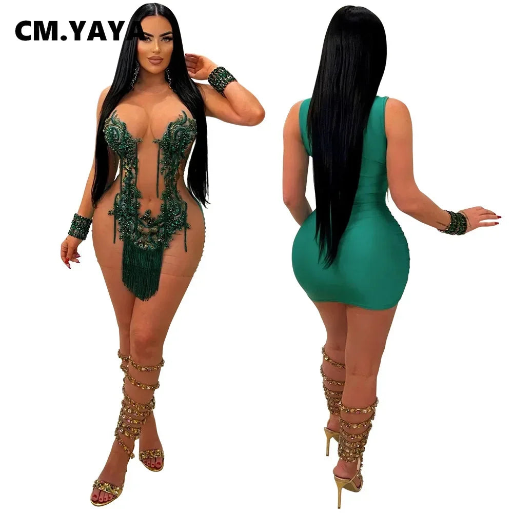 Green sleeveless mini dress with sequin embroidery, tassel fringe, and sheer mesh panels.