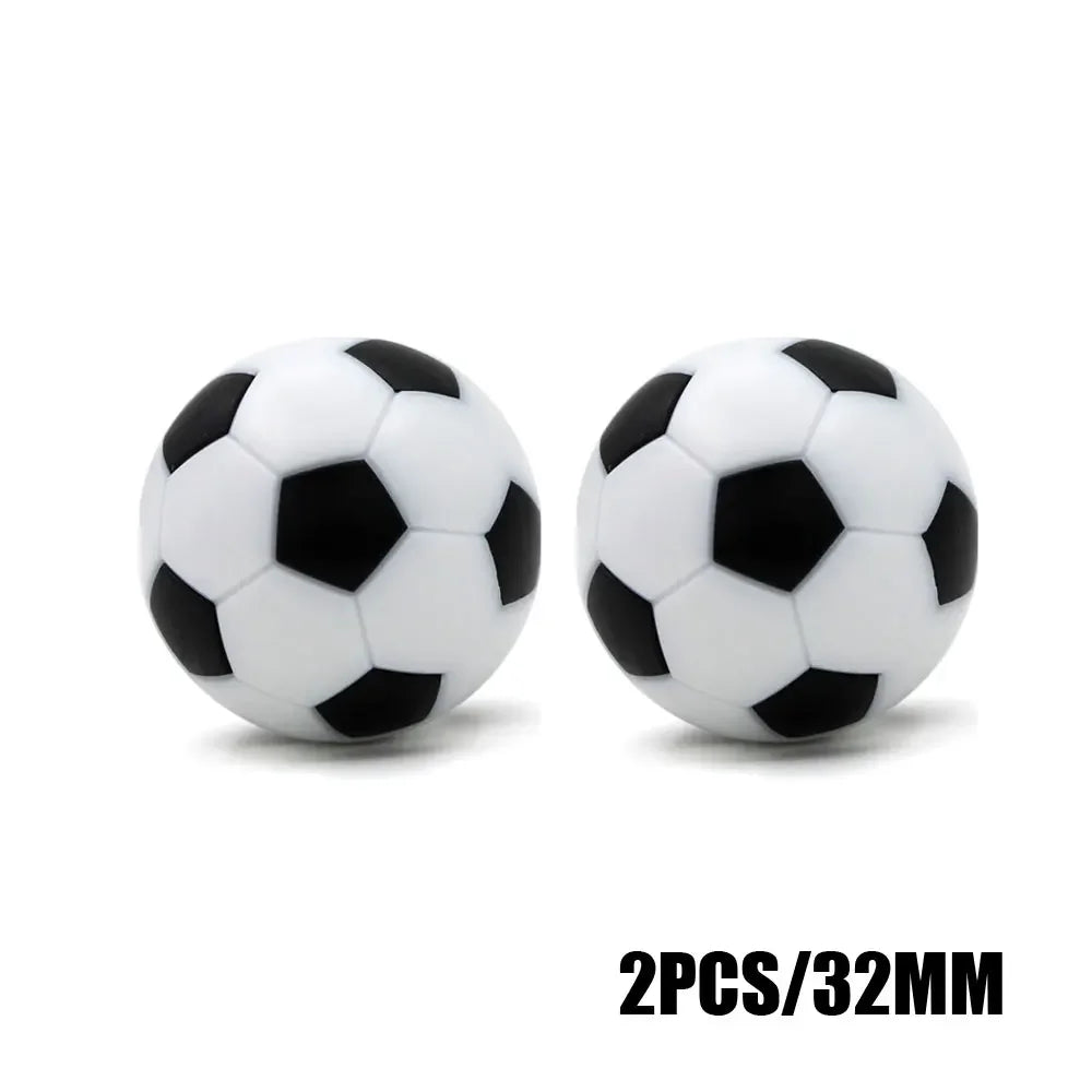 Two 32mm football-style balls with classic black and white pentagon patterns on a white background.