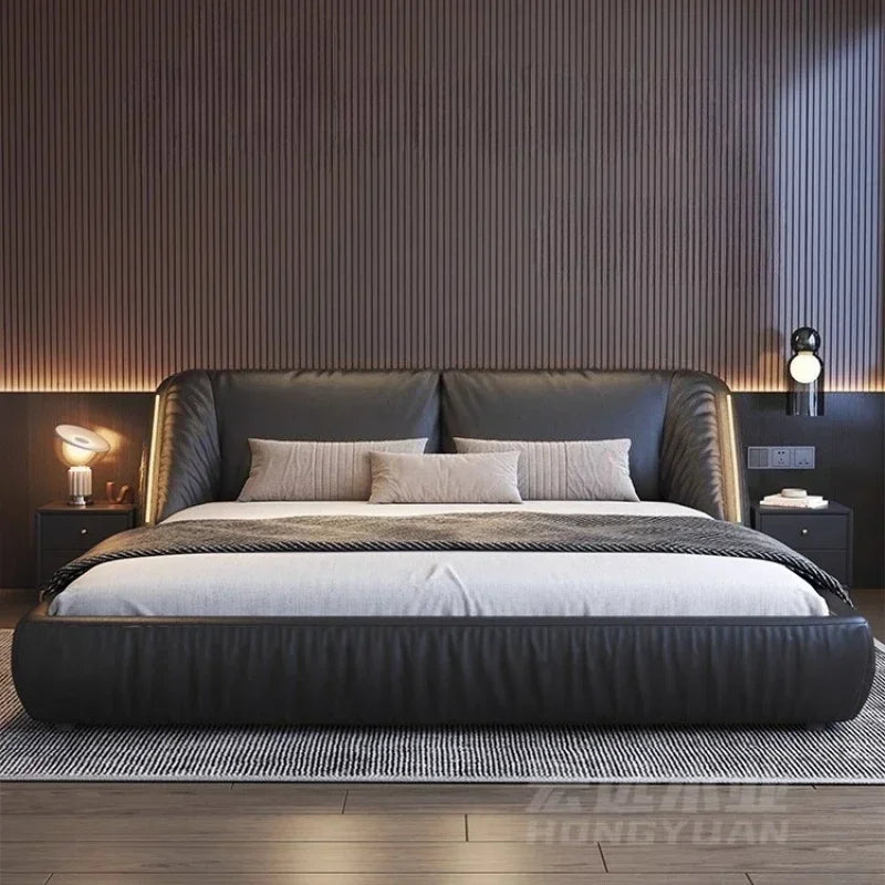 Modern king-size bed in dark grey, featuring a curved, upholstered headboard and low-profile design.