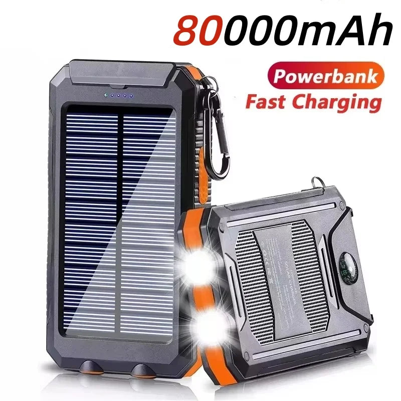 Black and orange rugged 80000mAh solar power bank with built-in LED torch, compass, and carabiner clip.