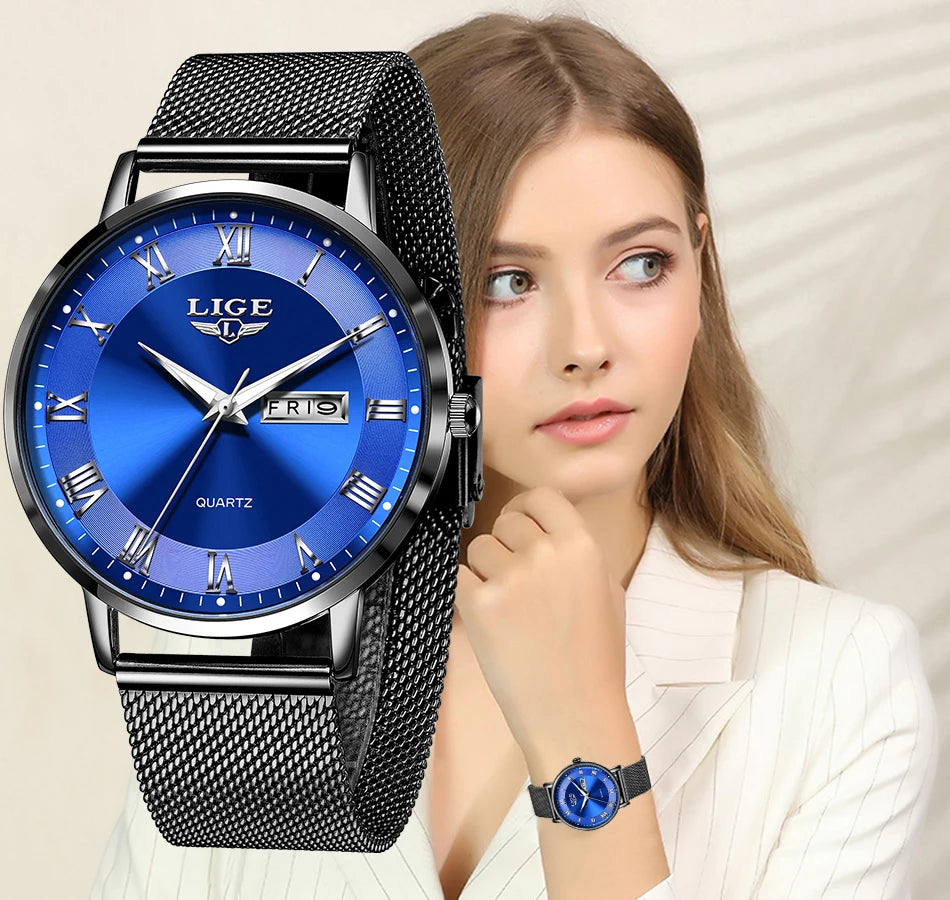 Elegant women’s watch with a deep blue dial, silver Roman numerals, and a sleek black stainless steel mesh strap.