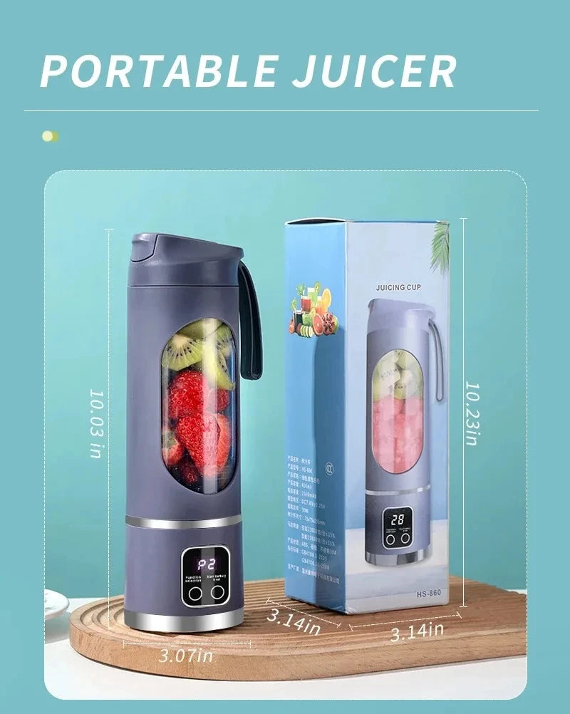 Grey portable electric juicer with a clear window showing fruit and a digital display base, next to its product box.