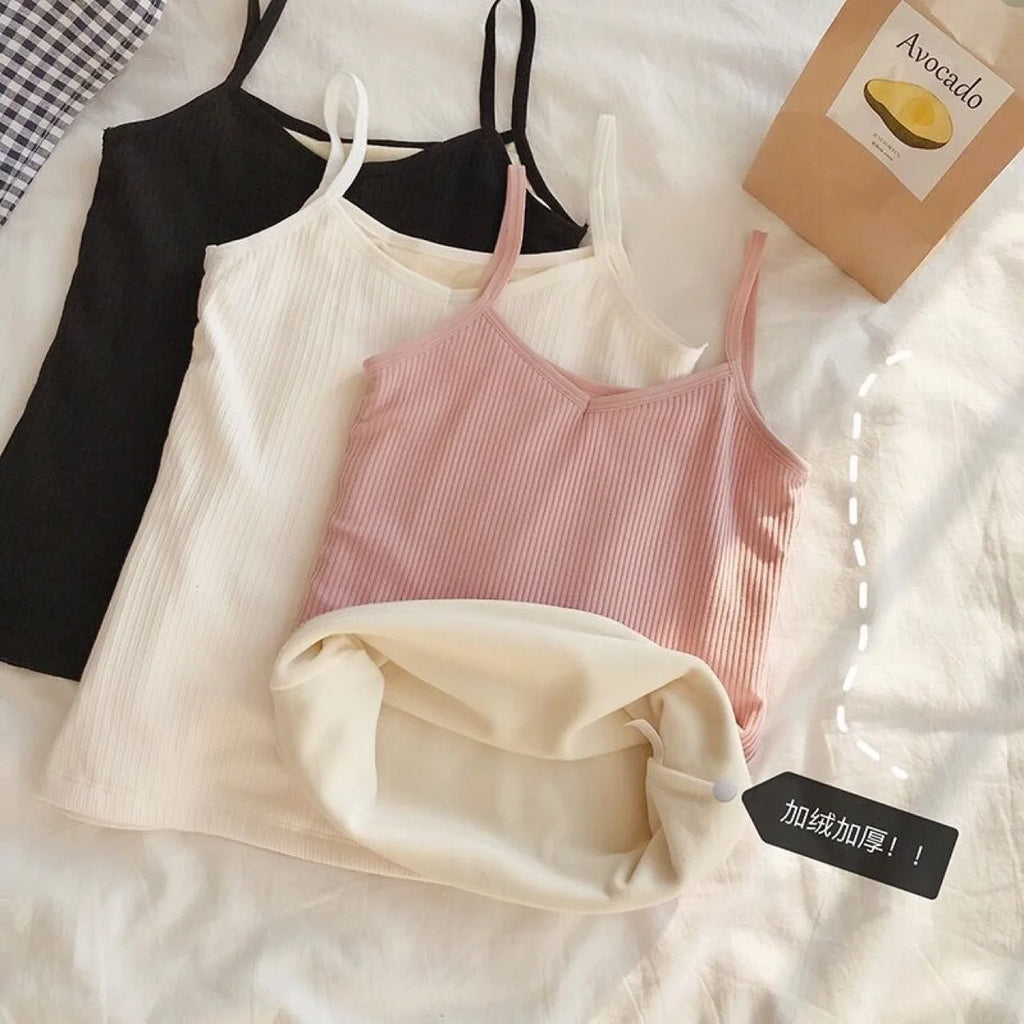 Three thermal camisole vests in black, white, and pink, featuring a ribbed design and soft, fleece-lined interior.
