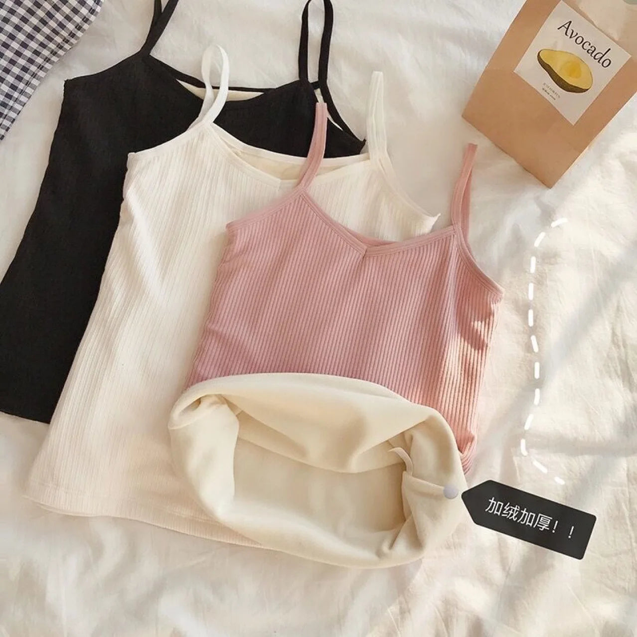 Three thermal camisole vests in black, white, and pink, featuring a ribbed design and soft, fleece-lined interior.