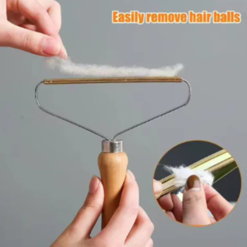 Handheld fabric shaver with a wooden handle and metal scraper removing lint from clothing.