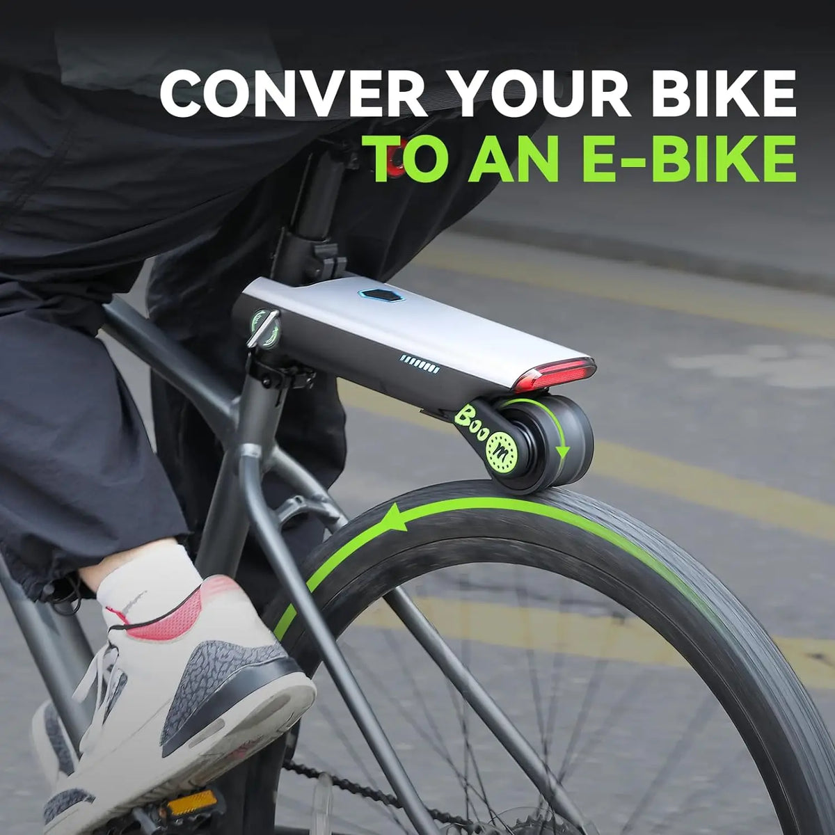 Silver and black electric bicycle booster mounted below the bike seat, driving the rear tire with a motorized wheel.