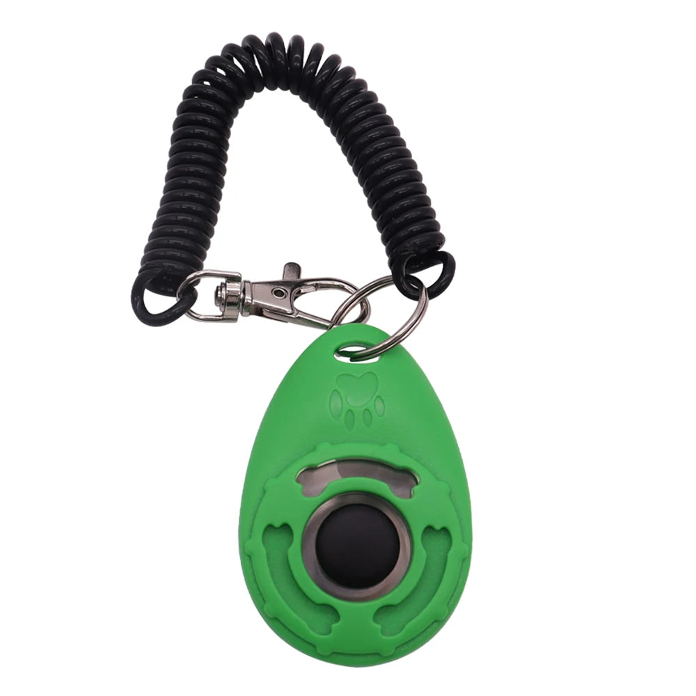 Green dog training clicker with a black push-button, featuring a paw print design and a black coiled wrist strap.