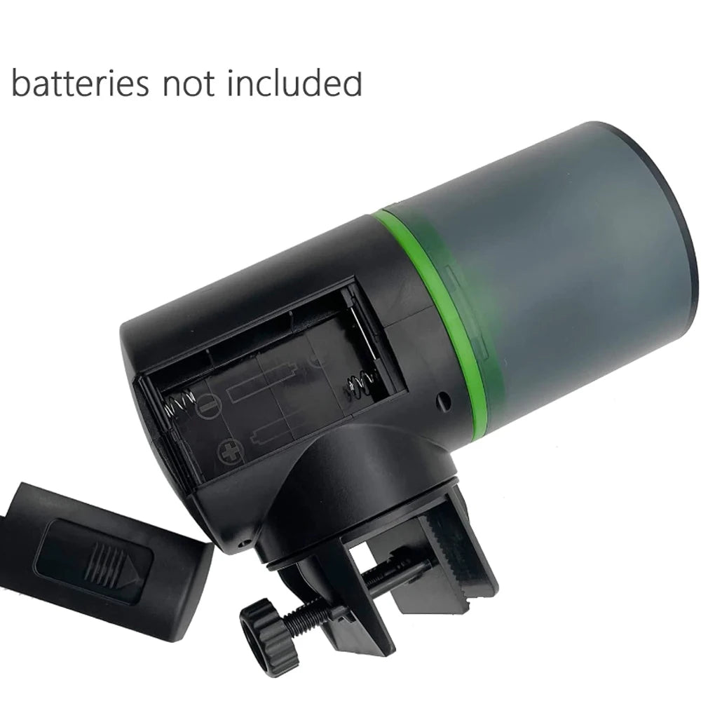 Black battery-operated clip-on fan with a green accent ring and detachable battery cover. White background.