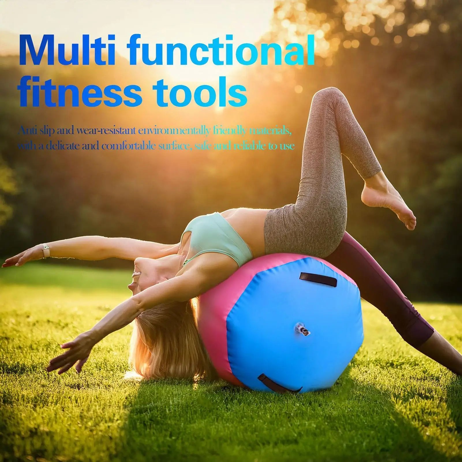 Woman stretching over a pink and blue inflatable gym barrel on grass at sunset.