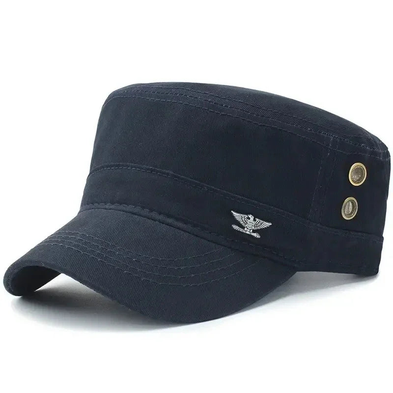 Black military-style cadet cap with a flat top, silver eagle emblem, and brass-tone ventilation eyelets on the side.