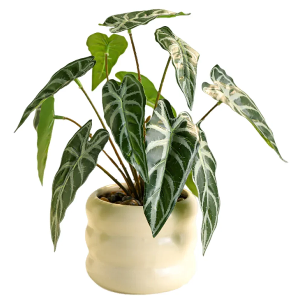 Artificial Alocasia plant with dark green, white-veined leaves in a round, cream-colored ceramic pot.