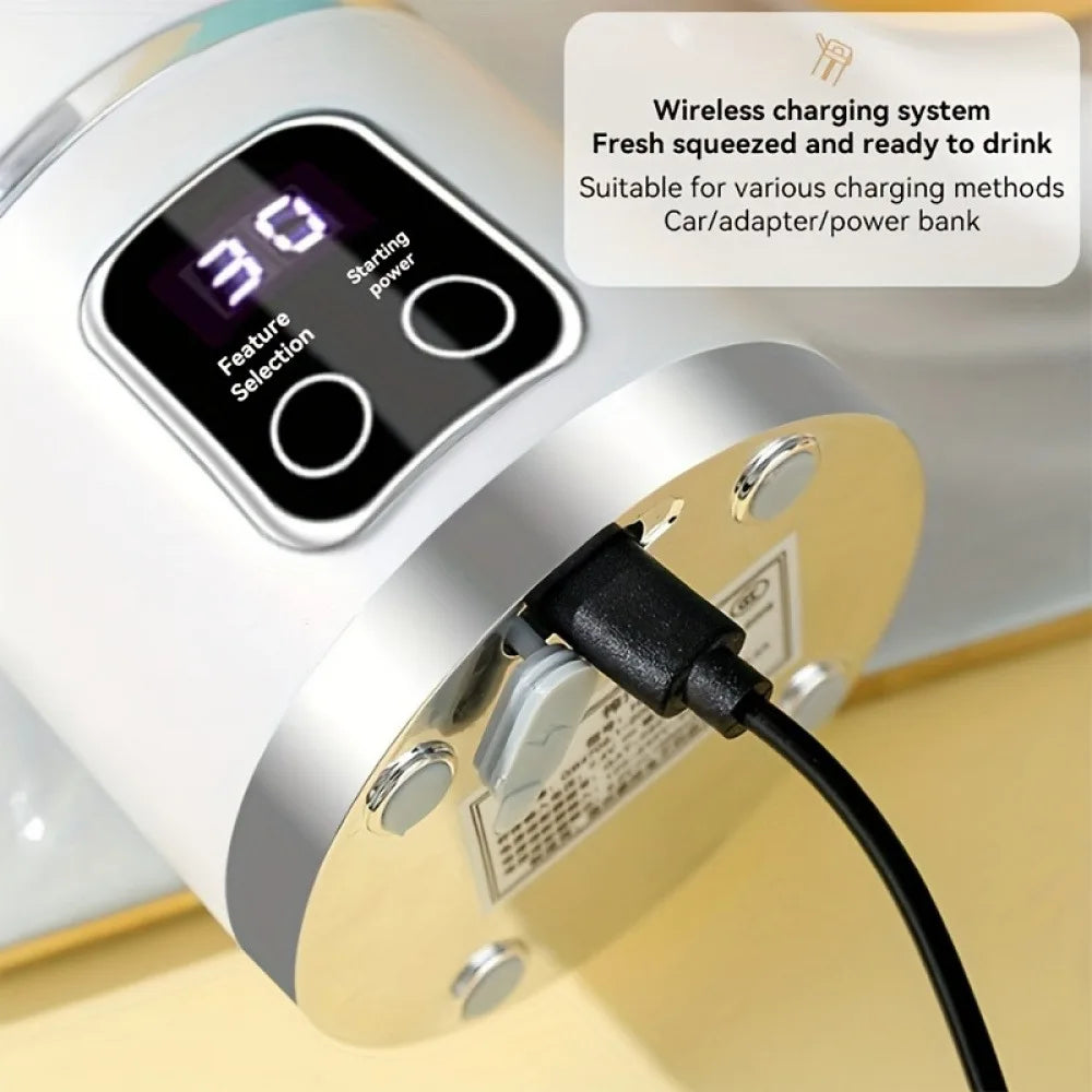 White portable blender with a digital display showing "30," charging via a black USB cable.