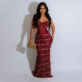 Burgundy sequin maxi dress featuring spaghetti straps, a sheer corset bodice, and floor-length fit.