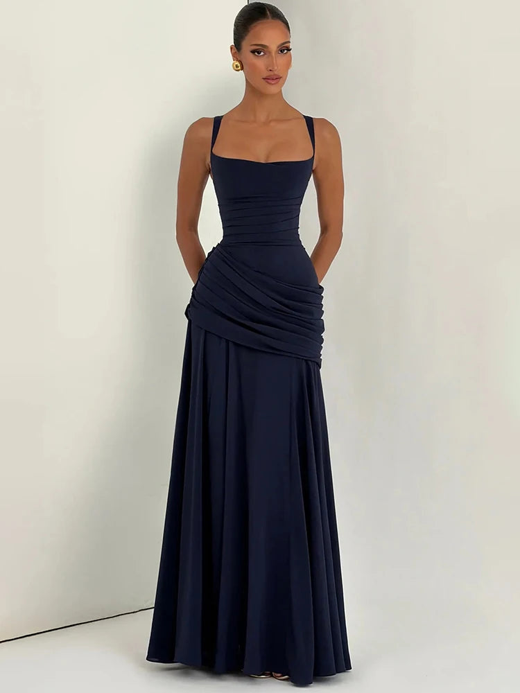 Navy blue sleeveless maxi dress with a square neckline, ruched bodice, and pleated long skirt.
