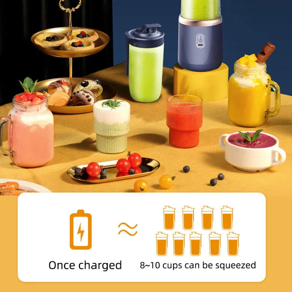 Portable dark blue and rose gold electric blender surrounded by various colourful smoothies and small pastries.