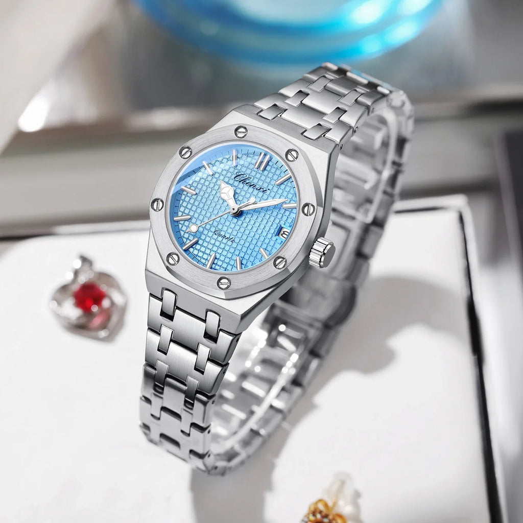 Luxury women’s silver stainless steel analogue watch with a textured light blue dial and a link bracelet strap.