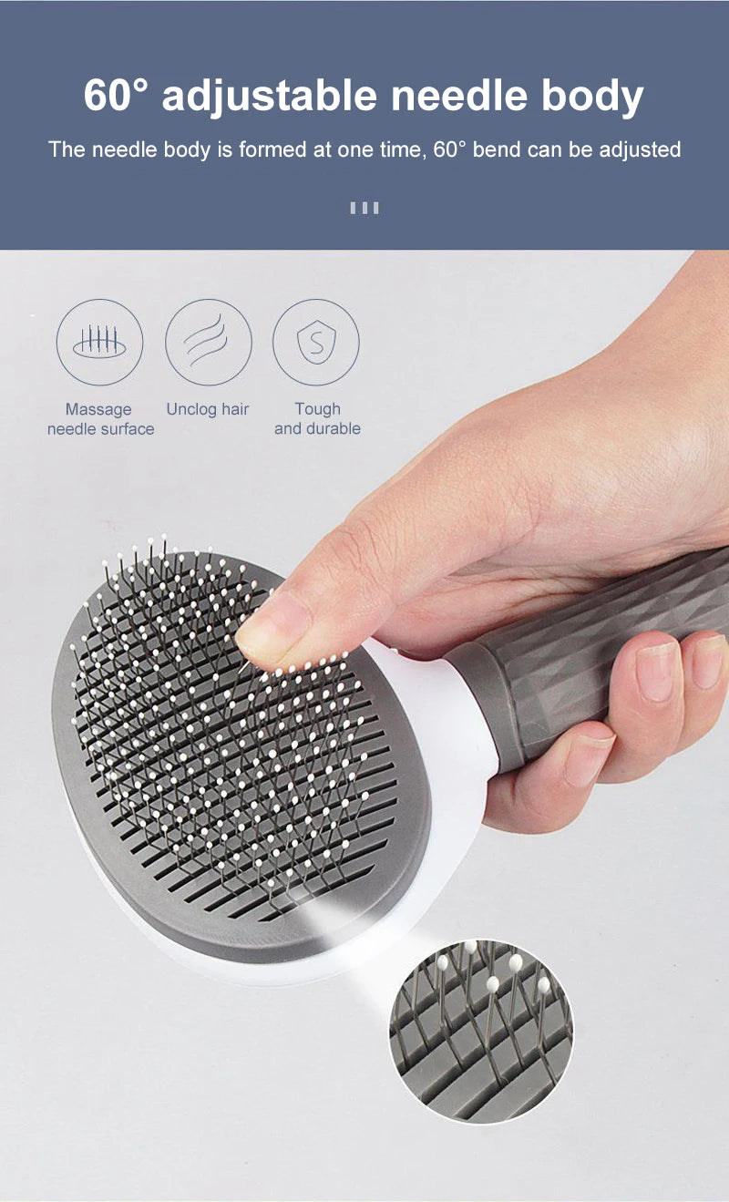 Grey pet grooming brush with an adjustable head, held in a hand. Features fine wire needles with white tips.