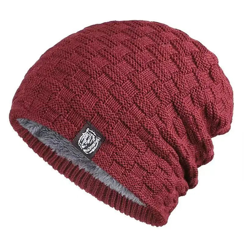 Deep red knitted beanie with a textured square pattern and a warm grey fleece lining.