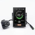 Black Bafang DPC18 e-bike display with color screen, speedometer, connected control pad, and cable with green pin plug.