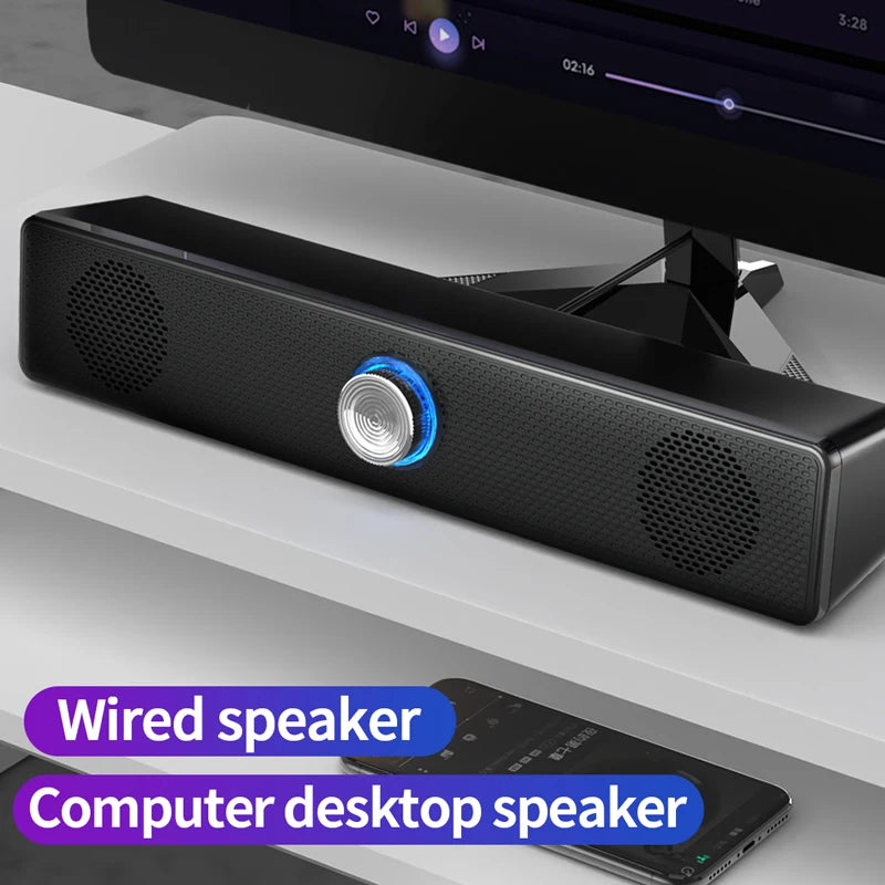 Sleek black wired USB soundbar for computers, featuring dual speakers and a central volume dial with blue LED light.
