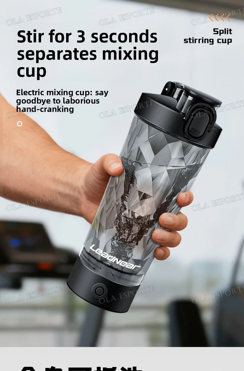 Handheld electric mixing cup with a black lid and a translucent, geometric-patterned body held by a person.