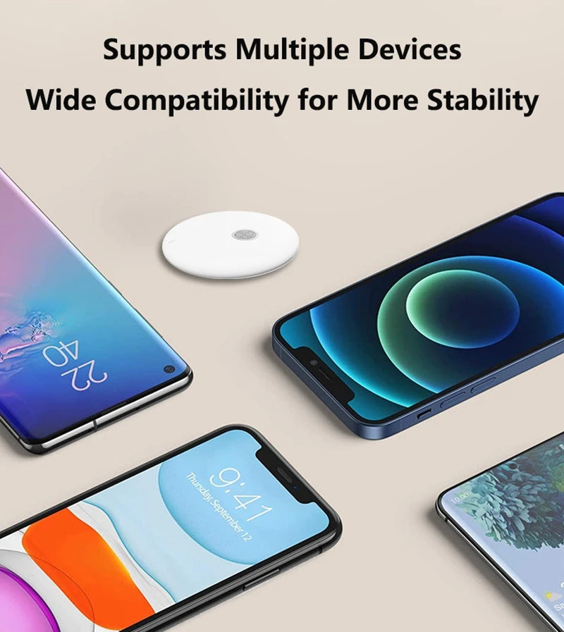 A small, white, round Bluetooth speaker surrounded by four different smartphones on a neutral background.