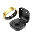 Gold smart fitness ring with interior health sensors, shown next to its black magnetic charging case.