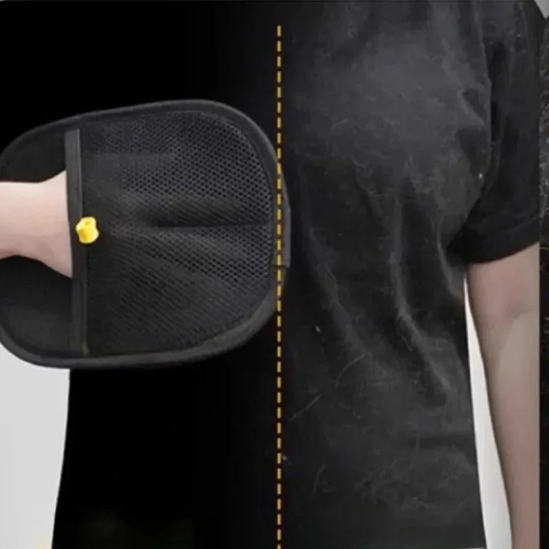 Black mesh lint removal mitt being used to clean pet hair from a black t-shirt.