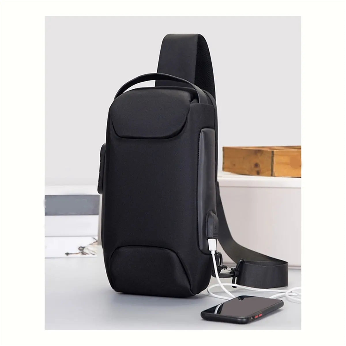 Sleek black, waterproof crossbody bag with an integrated USB charging port and adjustable shoulder strap.
